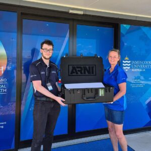The JCU team holding an open ARNI™ box, showcasing its compact and accessible design for business connectivity services. The ARNI™ box supports Point-to-Point (PTP) Connectivity, Point-to-Multipoint (PTMP) Connectivity, and business satellite internet solutions, providing long-range wireless communications and seamless wireless network solutions in remote locations.